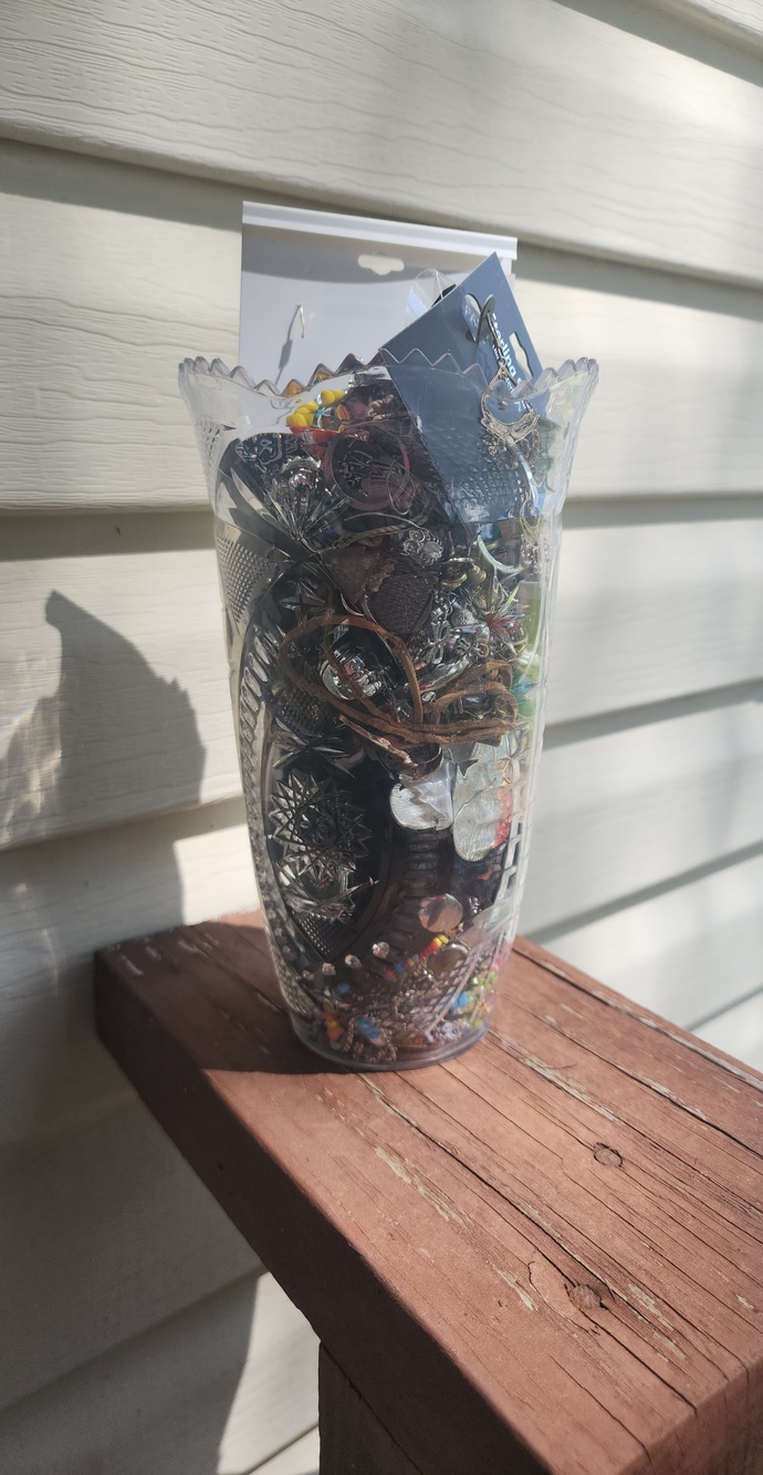Clear Decorative Plastic Vase Filled with Assorted Jewelry